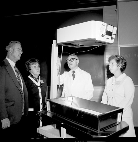 Doctors with infant nursery bed