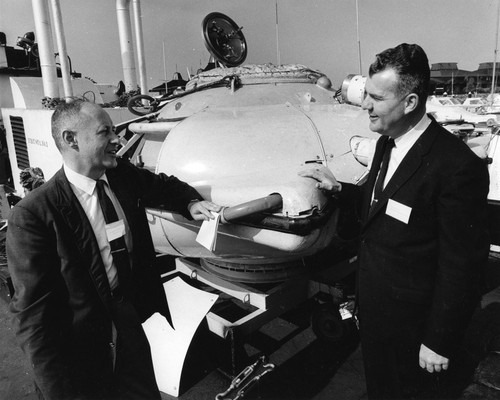 Fred Noel Spiess (left) and Jack Clotworthy (Westinghouse) standing in front of the Cousteau diving saucer (Denise)