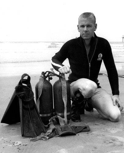 Earl A. Murray on the beach with diving equipment
