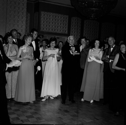 Chancellor William J. McGill (with scroll) and others at the UC San Diego Faculty Ball