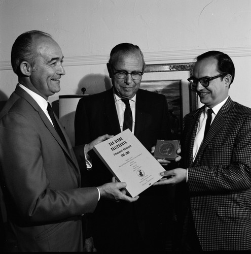 Melvin A. Voigt (center) receives bicentennial medal and bibliography celebrating 200th anniversary of San Diego