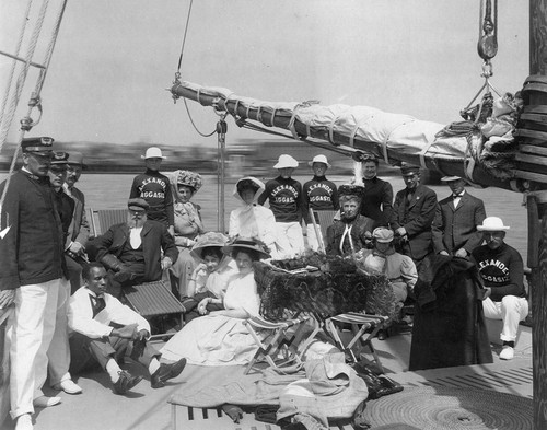 Edward Willis Scripps (sitting on chair), Robert P. Scripps (standing behind him), and wife of E.W. Scripps, along with unidentified friends and crew aboard the R/V Alexander Agassiz