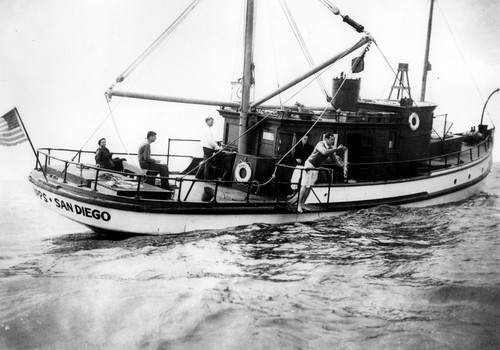 Roger Revelle (right) collecting water samples with unidentified, aboard the R/V E.W. Scripps