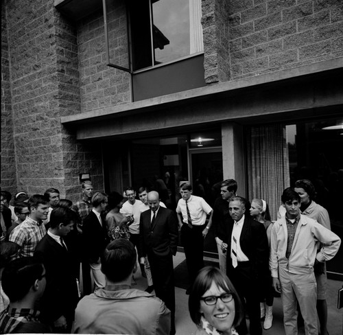 Clark Kerr and Edward Goldberg (back to camera) in discussion with group of students and faculty during installation of Galbraith as Chancellor, UC San Diego