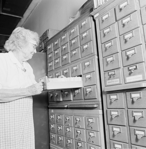 Laura Clark Hubbs with card catalog in the Hubbs Library