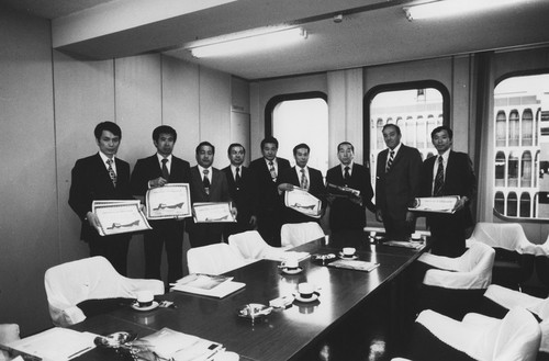 Robert Huffer (second from right) presenting certificates of appreciation to a group of representatives from Tokyo