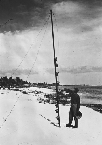 Jeffery Holter holding wave measurement instrument, Operation Crossroad, Bikini Island