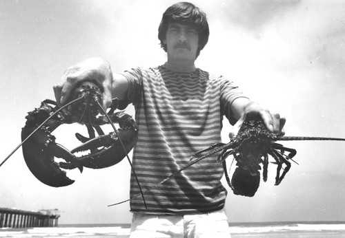 Charles J. Farwell holding lobsters
