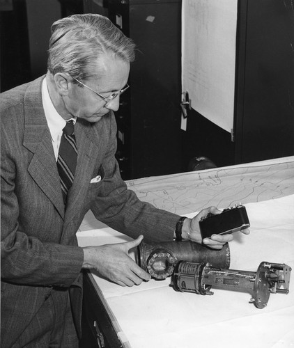 Francis P. Shepard examining mechanical equipment