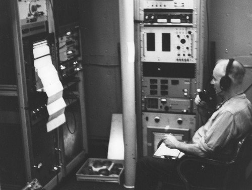 George Deacon operating radio aboard the USCGS Glacier, International Weddell Sea Expedition (IWOSE)