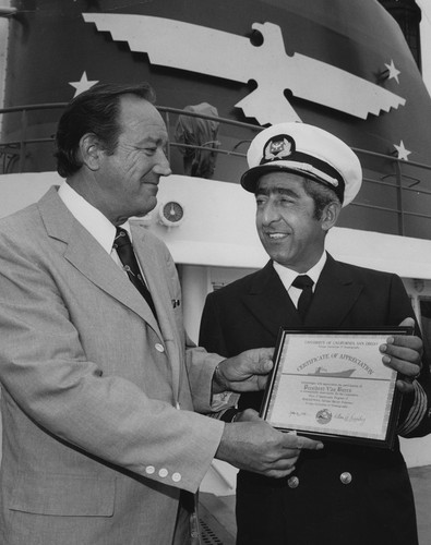 Robert Huffer (left) receiving certificate of appreciation from unidentified U.S. Navy officer