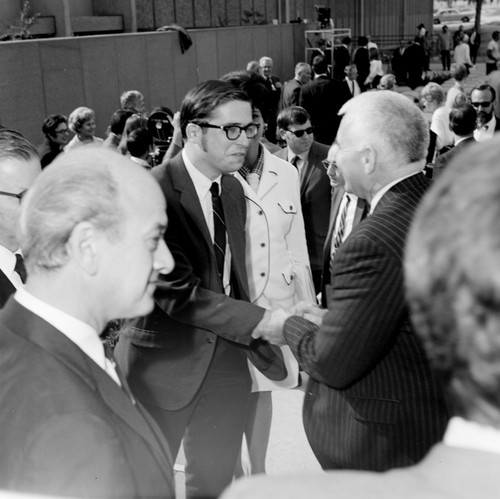 Chancellor William McGill (back towards camera) shaking hands with an unidentified man, dedication of the Basic Science Building, UC San Diego