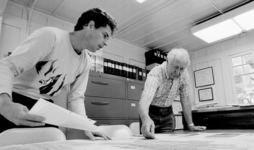 Fred Noel Spiess (right) and unidentified man, working in his office T-6