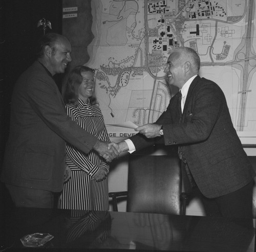 Chancellor William J. McGill presenting service award to Sam Hinton, as wife Leslie D. Hinton looks on