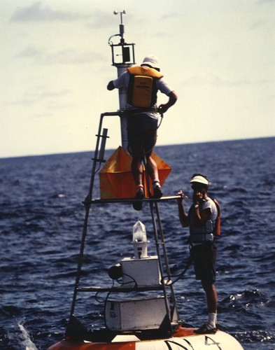 Doug Fenton and Robert A. Knox (right) adjusting anemometer atop surface buoy