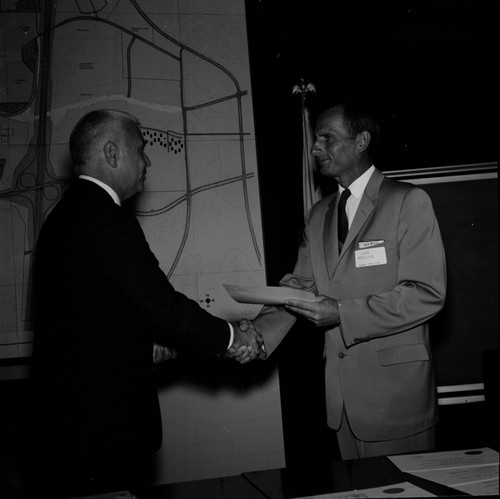 Chancellor William J. McGill presenting service award to Joe Mehling