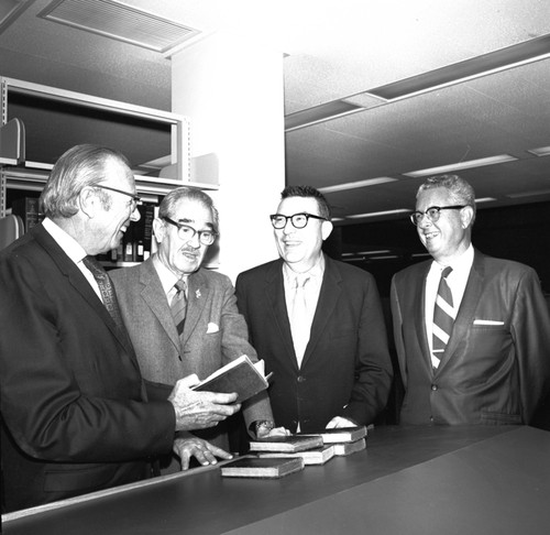 Melvin Voigt, Francis Smith, Herbert York, and an unidentified man during the ceremony commemorating the 3/4 million books at UC San Diego Libraries