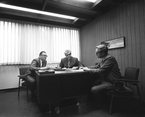 Roy Greaves, Willis Bergeson, and George Matson at desk, Purchasing Department, UC San Diego