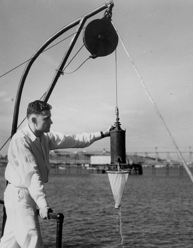 Roger Revelle with Allen bottle gathering phytoplankton samples