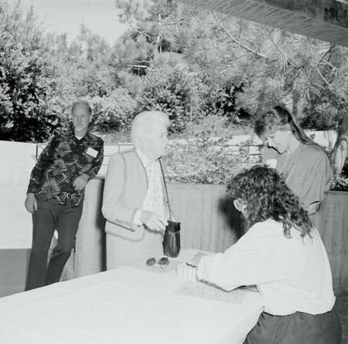 Ellen Virginia (Clark) Revelle checking in with George G. Shor in the background, Ellen Browning Scripps Memorial Pier rededication ceremony, Scripps Institution of Oceanography