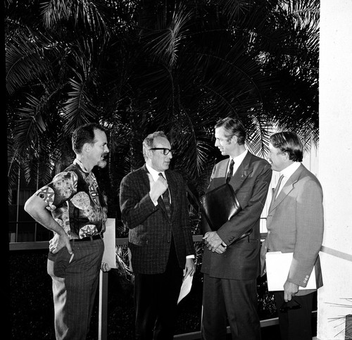 George G. Shor, William A. Nierenberg, Jacques Piccard, and Ronald Linsky talking prior to lecture, Scripps Institution of Oceanography