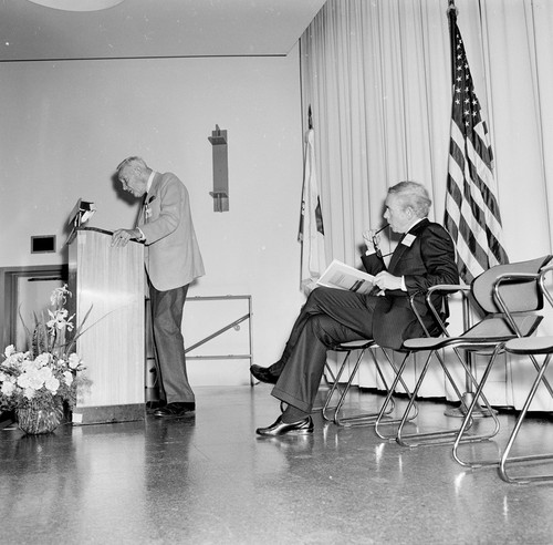 Roger Revelle (at podium) and Edward A. Frieman (seated), Ellen Browning Scripps Memorial Pier rededication ceremony, Scripps Institution of Oceanography