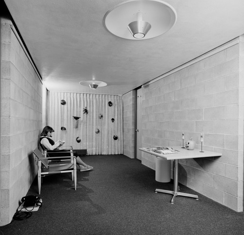 Woman seated in dormitory hallway, UC San Diego