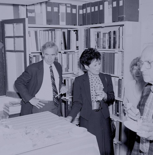 Edward A. Frieman (left) and Joy Frieman (center) with Fred Noel Spiess and Sally (Sarah Whitton) Spiess (right corner) at retirement party for Spiess