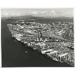 Aerial view of the Port of Oakland showing cranes and the eastern span of the Bay Bridge