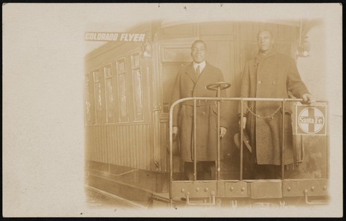 Two African American men in Colorado Flyer arcade photograph