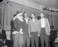 Male accapella group singing with santa