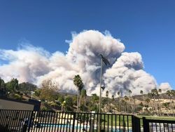 Smoke billows over hills