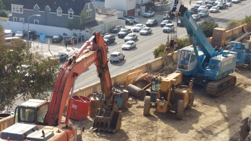 Caterpillar and Hitachi excavators at construction site, August 2, 2015