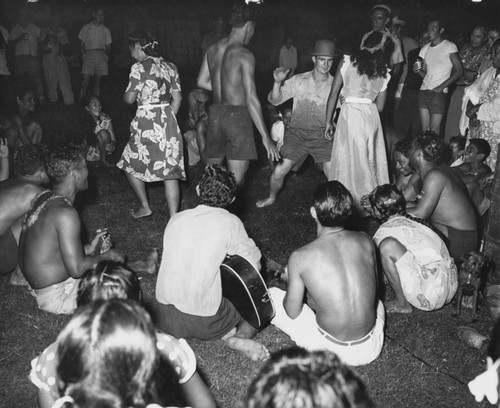 Crew members and locals at the village of Taiohae prepare to perform "loving pigs" dance, Marquesas Islands