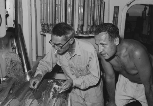 Milton Nunn Bramlette (left) and Roger Revelle review core samples aboard R/V Spencer F. Baird