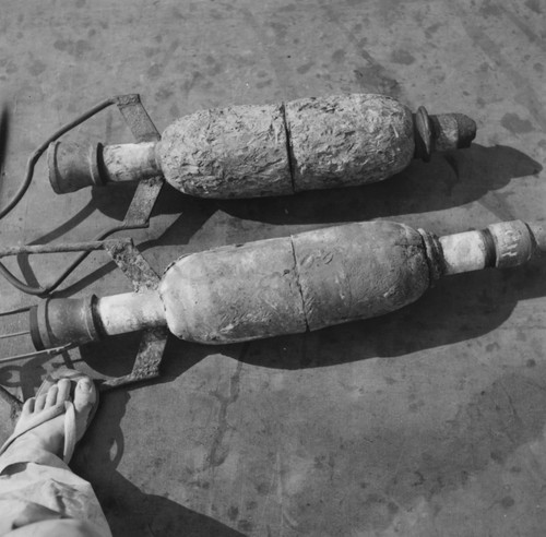 Damaged lead core barrel, retrieved from Tonga Trench, positioned next to a new one