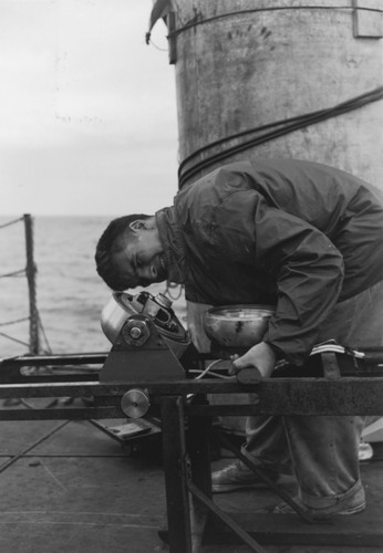 Robert Floyd Dill adjusts underwater camera aboard R/V Spencer F. Baird