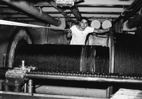 William C. King ("Buddy") stands behind the drum holding 40,000 foot tapered steel cable, R/V Spencer F. Baird