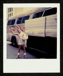 Chorus member in front of tour bus