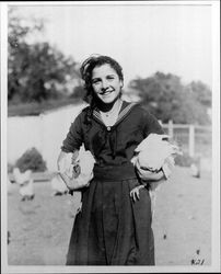 Unidentified girl holdings chickens at the Lytton Home, Lytton, California, 1921