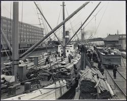 Unloading lumber, San Francisco, California, 1920s