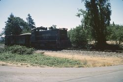 Southern Pacific train carrying gravel at Hurlbut Avenue crossing, Sebastopol, Calif., July 1977