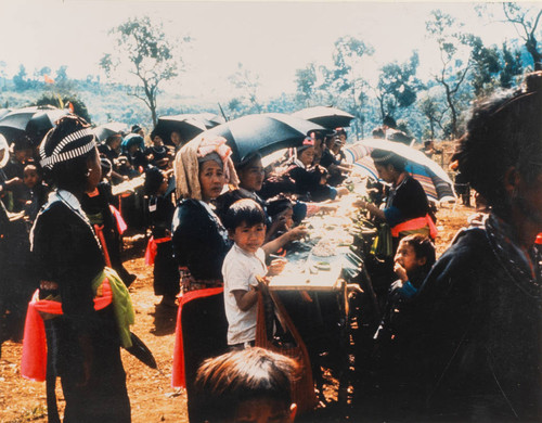 White HMong Women and Children Eating at HMong New Year Celebration in Laos