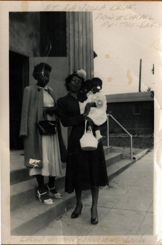 Leola Wright (left) and Jean King with a baby in front of First AME Church Santa Monica