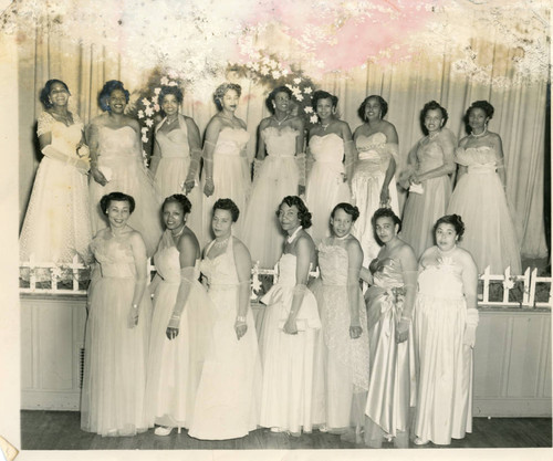 Women in formal wear at a Les Unique Social Club event