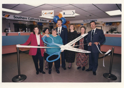 Judy Abdo (holding a pair of ribbon cutting scissors) and others in Southern California Edison Office in Santa Monica