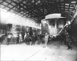 Men standing in the interior of the Petaluma and Santa Rosa Railway car barns