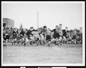 A close-up view of players during a rugby game, ca.1910