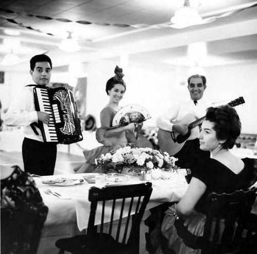 Woman being entertained by musicians at the 185th birthday of Los Angeles