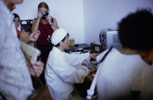 Worker operating an oscilloscope